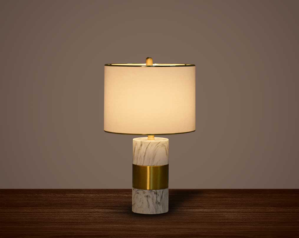 this table lamp in gold plated metal & marble base. It comes with a round translucent fabric shade in modern chic design.