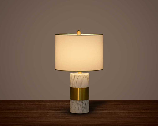 this table lamp in gold plated metal & marble base. It comes with a round translucent fabric shade in modern chic design.