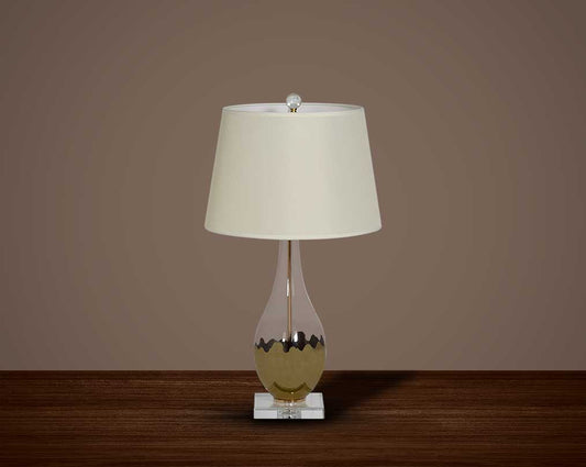 Table lamp with metallic silver and glass decorative base with translucent fabric shade.