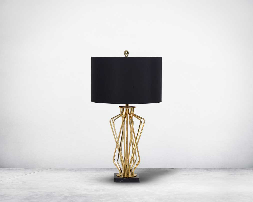 Table lamp in gold finish and marble base with a black fabric shade in ultra modern design.