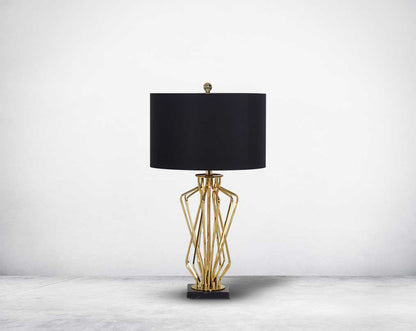 Table lamp in gold finish and marble base with a black fabric shade in ultra modern design.