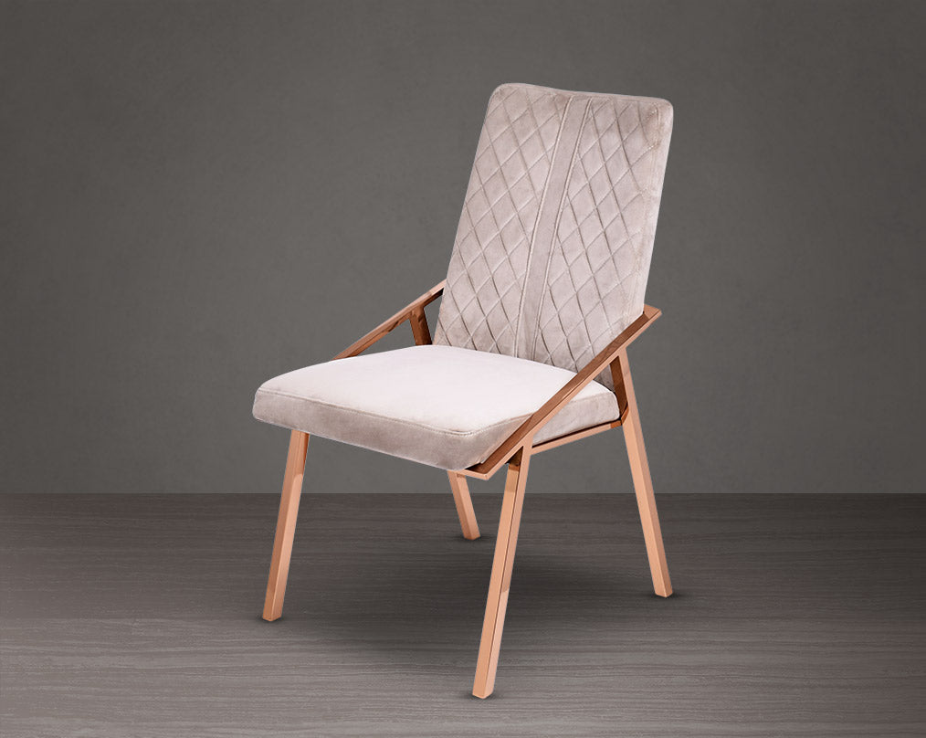 Dining chair upholstered in fabric with rose gold plated stainless steel legs.