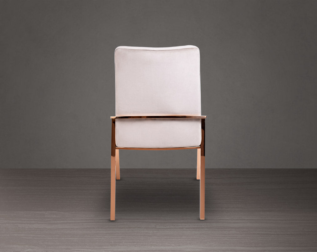 Dining chair back with  upholstered in fabric with rose gold plated stainless steel legs.