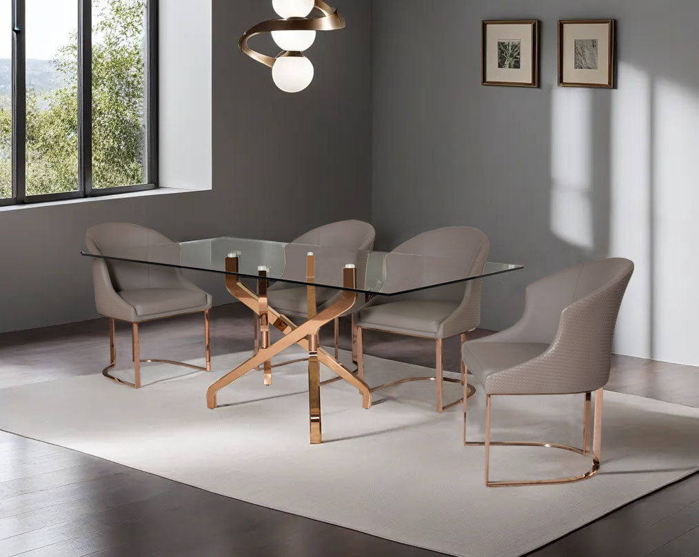 This chic 6 seater rectangular dining table with tempered glass table top which creates a striking contrast with shiny rose gold plated criss cross stainless steel base in rich contemporary design A chic chair with a lavish appeal with faux leather uphols