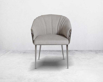 This predominantly eclectic and contemporary dining chair is upholstered in boucle fabric with glossy stainless steel frame & legs