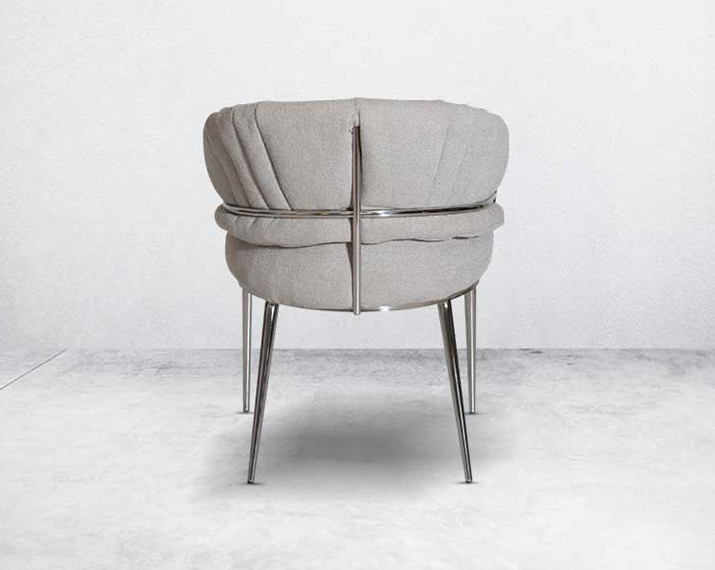 This predominantly eclectic and contemporary dining chair is upholstered in boucle fabric with back  glossy stainless steel frame & legs 