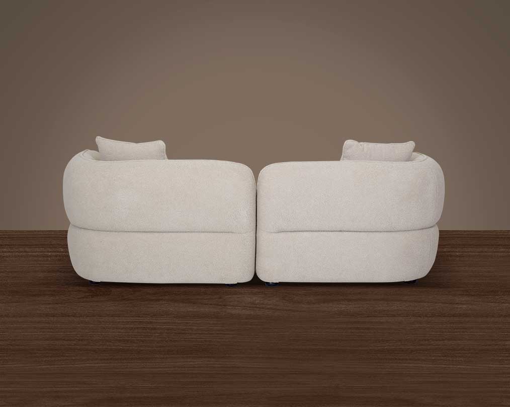 This 2 sofa set behind with white colour   is an embodiment of modern elegance with clean lines softened by subtle curves.
