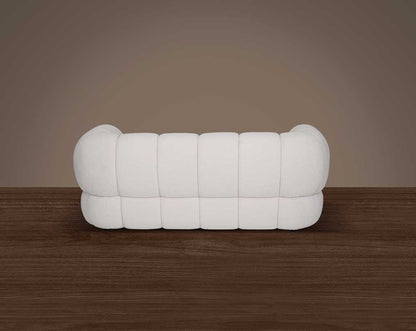 This sinuous & soft 2 seater sofa exudes a sense of calm & ease, upholstered in high-quality boucle fabric with wooden legs back view