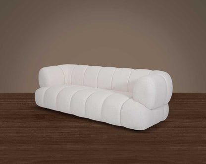 This sinuous & soft 3 seater sofa exudes a sense of calm & ease, upholstered in high-quality boucle fabric with wooden legs side view