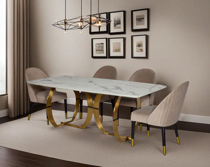 This beautiful & delicate 6 & 8 seater marble dining table is crafted to perfection. It is cast with a natural white a cursive artful base in matt gold plated stainless steel. "Minimalistically designed chair with wooden legs for enhanced durability. it i