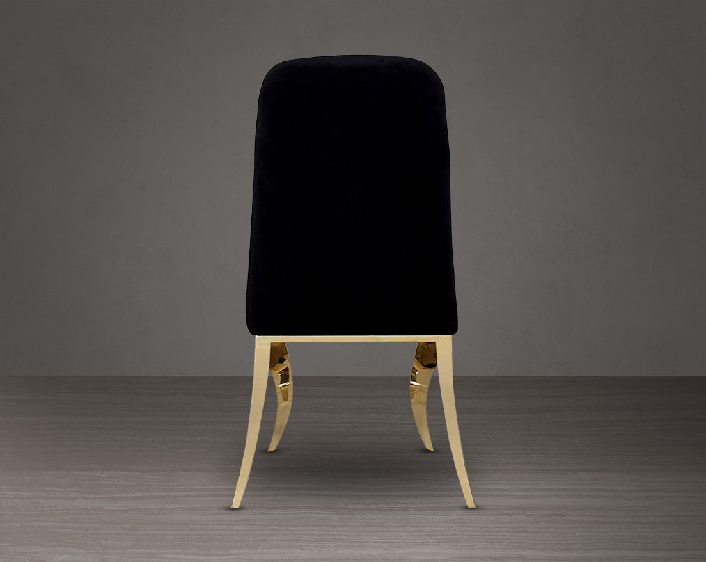Dining chair upholstered in back view fabric with gold plated stainless steel legs.