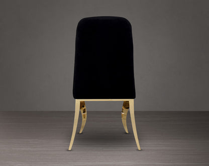 Dining chair upholstered in back view fabric with gold plated stainless steel legs.