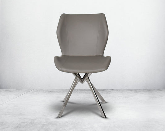 Dining chair upholstered in faux leather with stainless steel legs front view