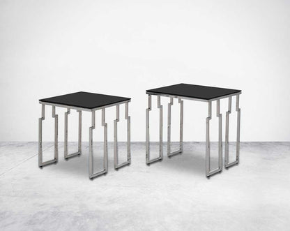 Nested tables in a set of 2 with black tempered glass top and high polished stainless steel base in rich contemporary design.