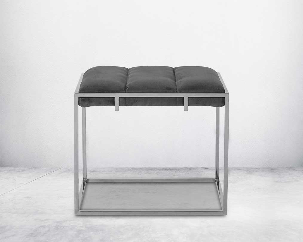 Ottoman upholstered in fabric with high polished stainless steel frame and legs front view
