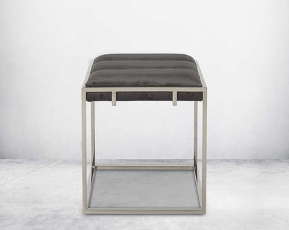 Ottoman upholstered in fabric with high polished stainless steel frame and legs.
