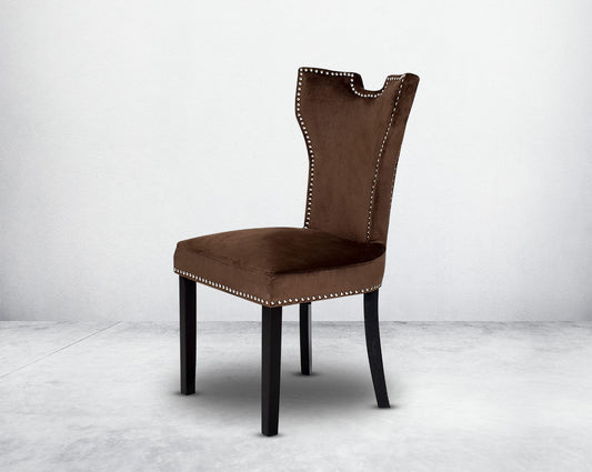 Dining chair upholstered in fabric with legs in wood. Stainless steel decorative ring at the back with stainless steel rivets.