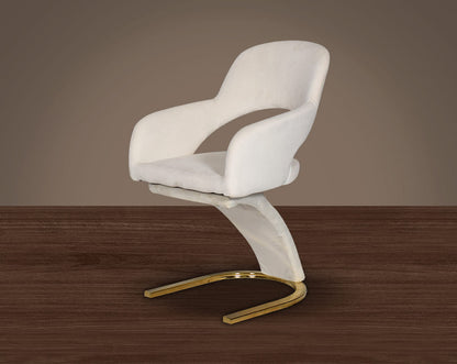 This dining chair features an extraordinary design with a backrest and a cushioned seat upholstered in velvet. It has a horseshoe motif gold plated metal base which adds a modern glamorous look to any space