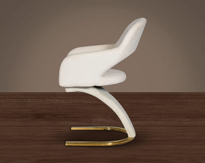 This dining chair features an extraordinary design with a backrest and a cushioned seat upholstered in velvet. It has a horseshoe motif gold plated metal base which adds a modern glamorous look to any space