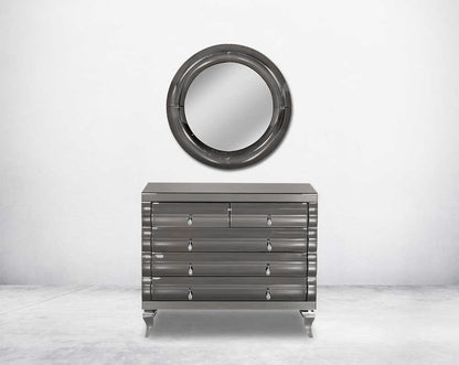 Chest of drawers in a grey curved mirror.