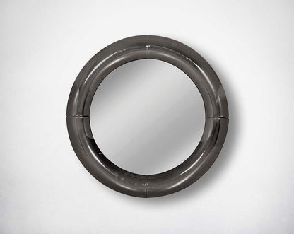Round wall mirror with grey curved mirror border in rich contemporary design.