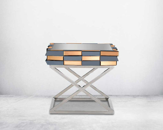 End table with clear glass top with grey & tawny mirror & high polished stainless steel legs in a cross design front view