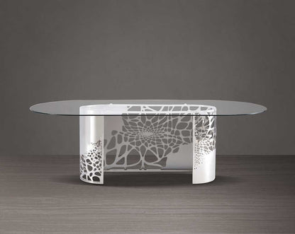 This exquisite & beautiful dining table with an artistic laser cut base in glossy stainless steel base with clear bevelled tempered glass top in a sumptuous the style of your space.