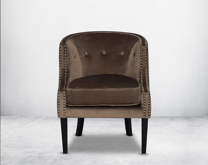 Wing arm chair upholstered in velvet fabric front with   and tufted with steel rivets and legs in brown oak.