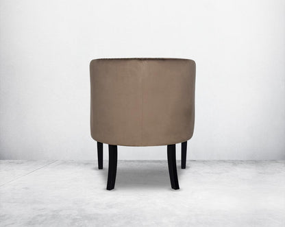 Wing arm chair upholstered in velvet fabric back with  and tufted with steel rivets and legs in brown oak.