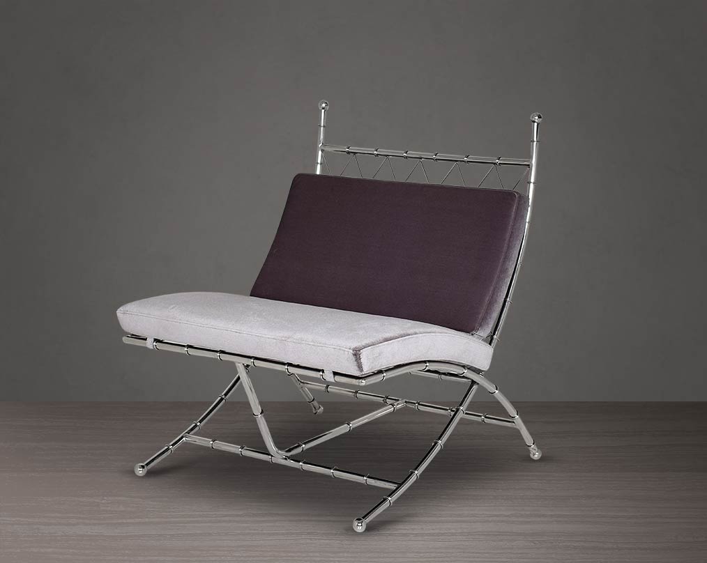 Lounge chair upholstered in fabric with high polished stainless steel frame in bamboo design.