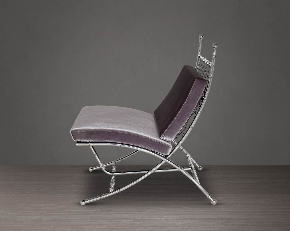 Lounge chair upholstered in fabric with high polished stainless steel frame in bamboo design.