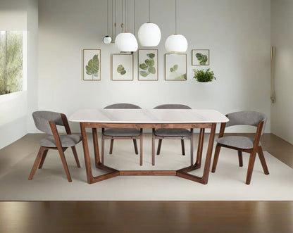 6 seater rectangular dining table with white marble top and legs in walnut.Dining chair in walnut with seat upholstered in fabric.