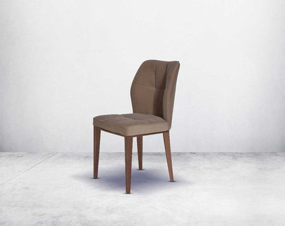 Dining chair upholstered in velvet fabric with high polished rose gold stainless steel legs.