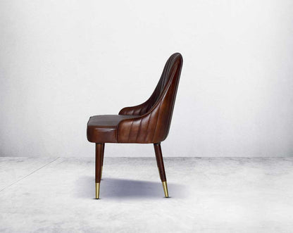 This rich contemporary dining chair in genuine leather makes for a luxurious dining experience. It comes with a quilted cushioned back in acacia wood with metal splayed legs.