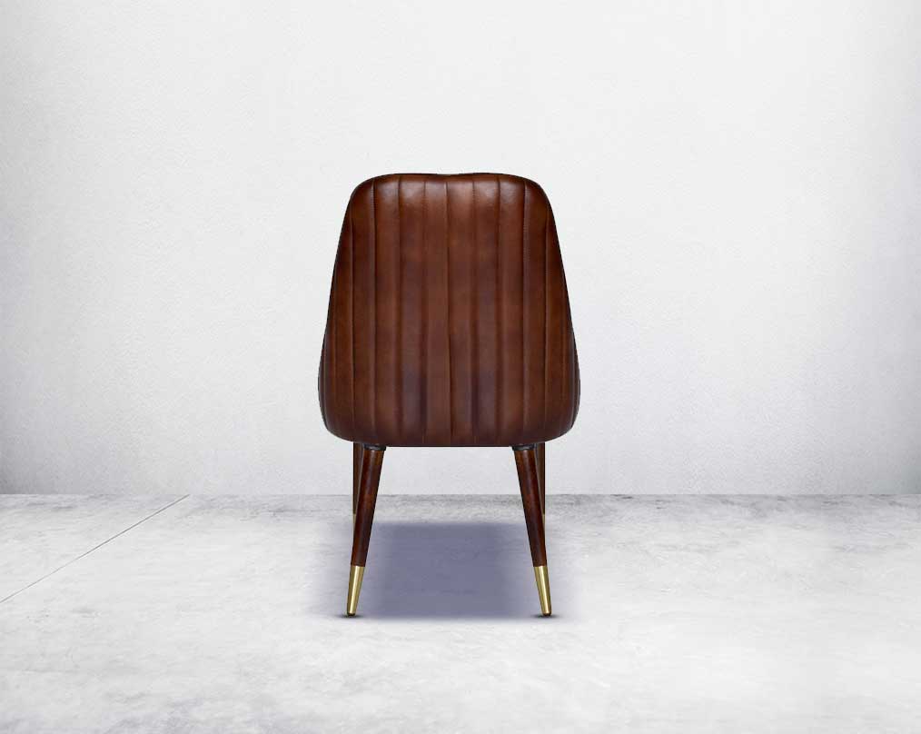 This rich contemporary dining chair in genuine leather makes for a luxurious dining experience. It comes with a quilted cushioned back in acacia wood with metal splayed legs.