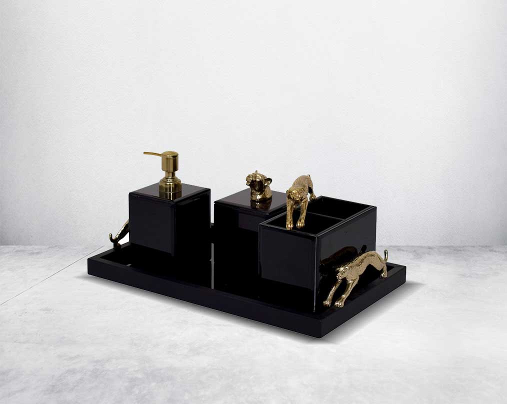 This modern & glam bathroom accessory designer set comprises a soap/lotion dispenser, a cotton jar, a tissue box & a tray in black glass with a gold leopard design motif making this set a perfect addition for a touch of allure to any bathroom.