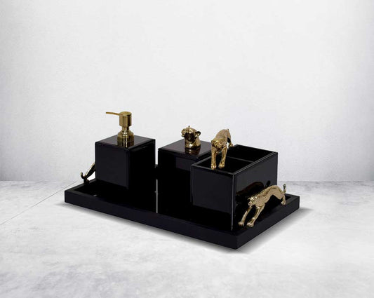 This modern & glam bathroom accessory designer set comprises a soap/lotion dispenser, a cotton jar, a tissue box & a tray in black glass with a gold leopard design motif making this set a perfect addition for a touch of allure to any bathroom.