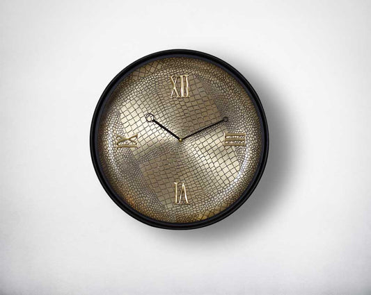 Round wall clock in croc etched design with a matt antique brass finish in black polish with roman numerals in rich contemporary design.