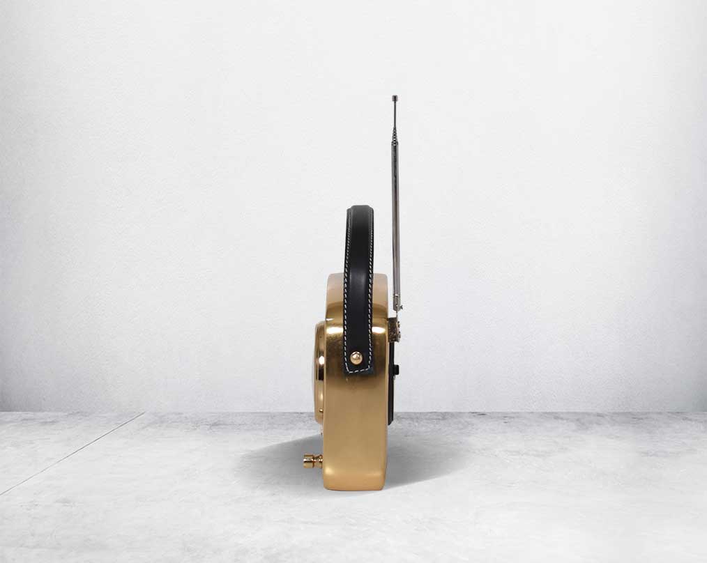 This unique retro table clock is sure to make a statement in any home. It is crafted in antique brass. Has a functional cock in vintage radio design. It has a leather strap hence easy to move around.