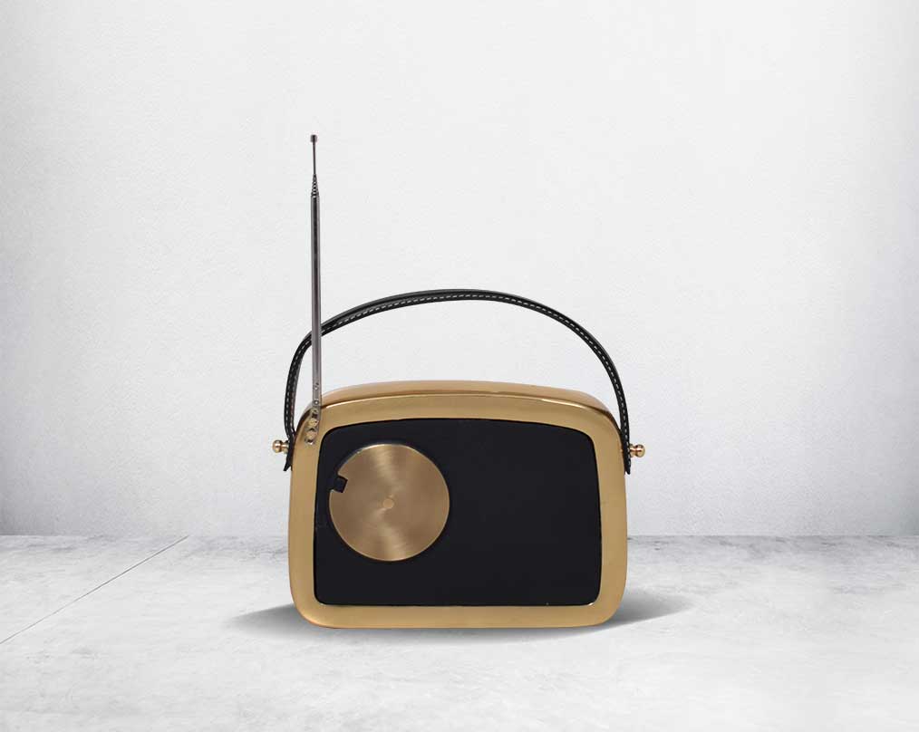 This unique retro table clock back with sure to make a statement in any home. It is crafted in antique brass. Has a functional cock in vintage radio design. 