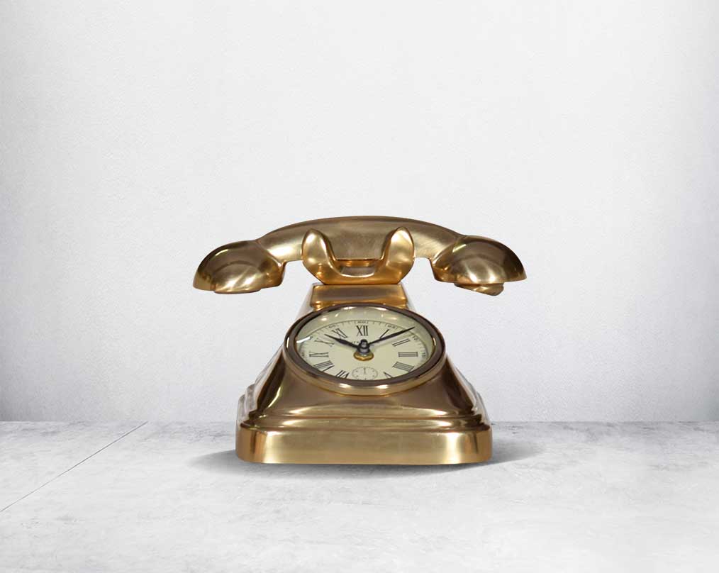This unique vintage telephone table clock comes with a clock in the centre. This antique clock is made out of brass in an antique matt finish