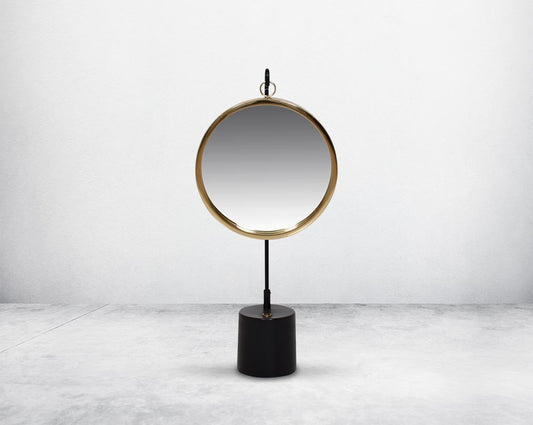 Round table dresser mirror suspended on a hook in shiny antique brass & matt black finished base. The look is very retro modern.