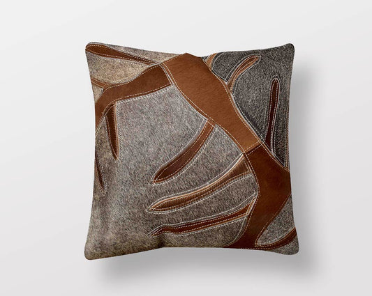 Brown and grey hair on a leather cushion.