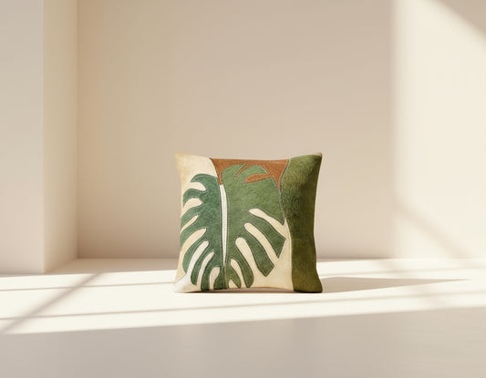 Beige and green hair on a leather cushion.