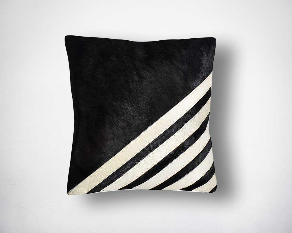 White, black & grey hair on a leather cushion.
