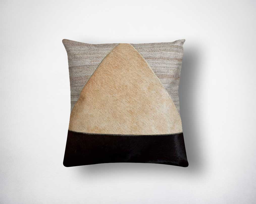 Beige, grey and black cut-out hair on and fabric cushion.