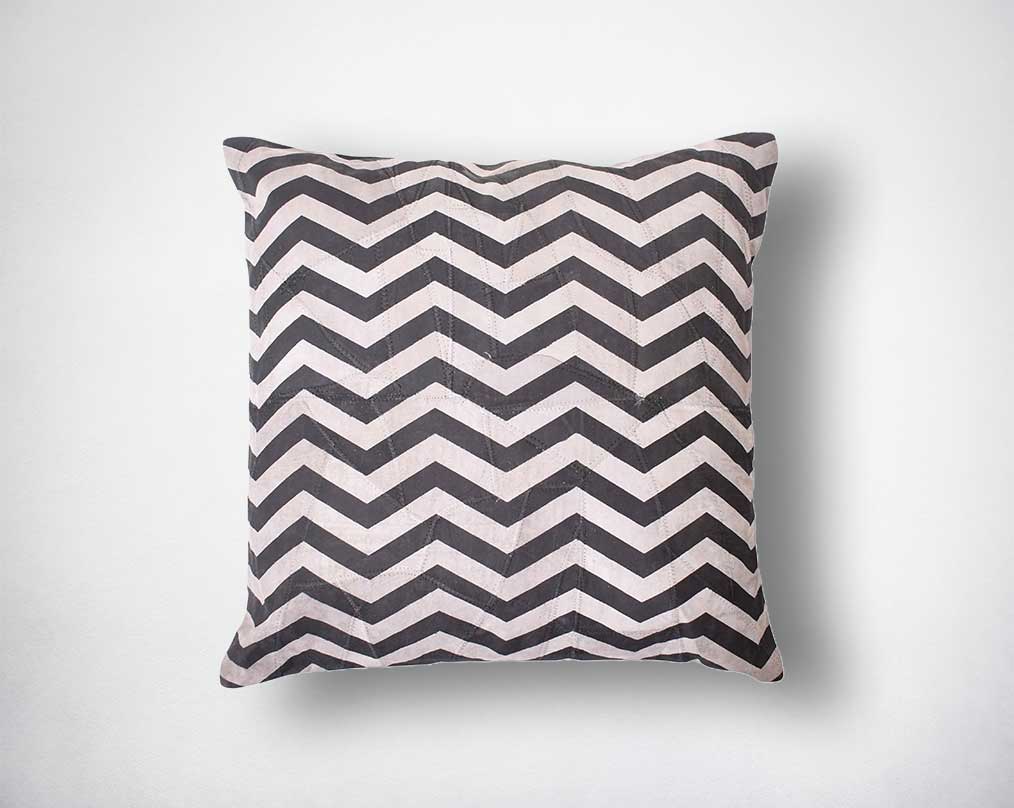 Patch suede leather cushion with geometric wavy print.