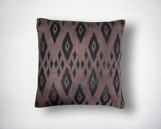 Leather cushion with eye print.