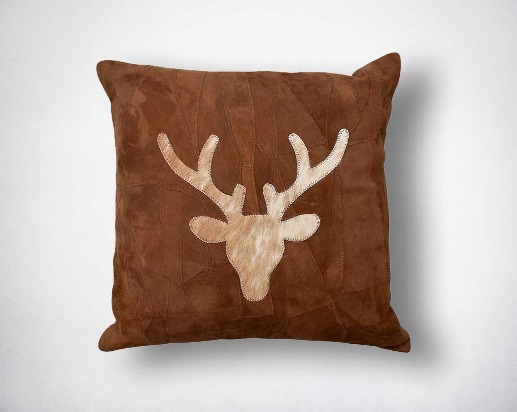Patched suede leather cushion with hair on deer face applique.