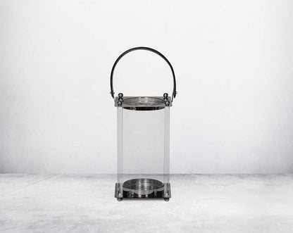 This lantern is crafted from leather, glass, and stainless steel and is perfect for adding aesthetic warmth and conviviality in any nighttime outdoor space. small
